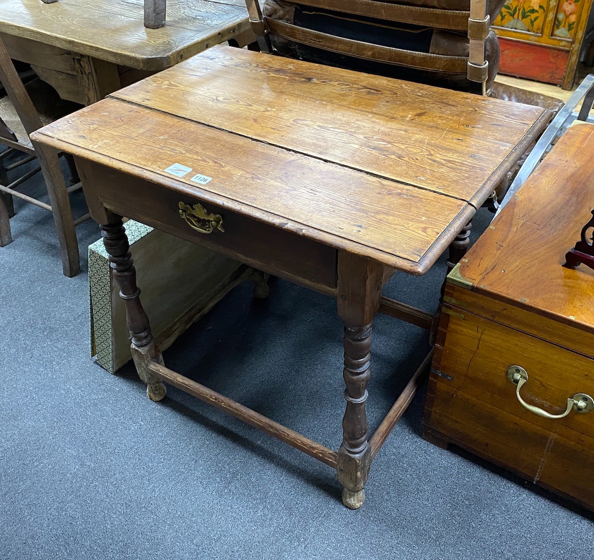 An early 18th century pine topped side table, fitted with a drawer, width 84cm, depth 59cm, height 74cm